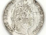 a close up of a coin on a white surface