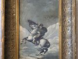 painting of a man on a horse in a gold frame on a wall