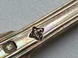 a close up of a silver knife on a table