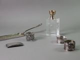 a bottle, spoon, and other items that are on a table