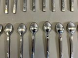 many spoons and spoon spoons lined up on a table