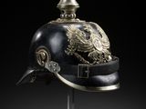 an officer ' s helmet with a gold eagle on it