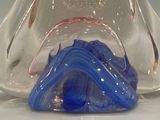 a glass vase that has a blue and white design on it