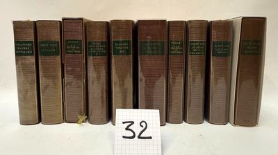 several old books are lined up on a table with a number 32