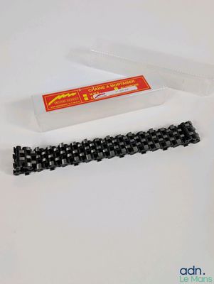 a close up of a chain and a plastic container on a table