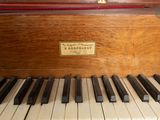 a close up of a piano keyboard with a plaque on it