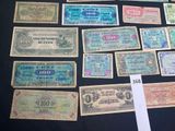 several different types of paper money are displayed on a table