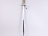 a close up of a sword on a white surface