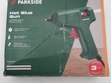 the box of a hot glue gun is open on the table
