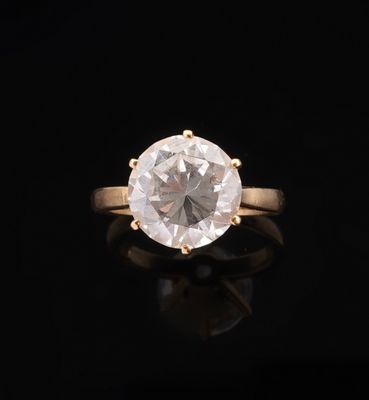 an engagement ring with a white diamond on a black background