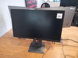 a computer monitor sitting on top of a wooden desk