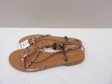 tan leather sandals with braid straps on a white surface