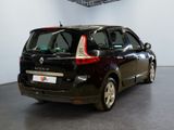 a picture of a small black car parked in a garage