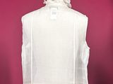 an image of a white dress on a mannequin with a pink background