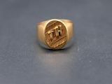 an image of a gold signet ring with the letter h on it