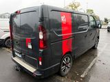 a black van with red stripes parked in a parking lot