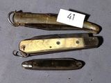 three knives are sitting next to each other on a table