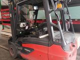 a red forklift truck parked in a warehouse