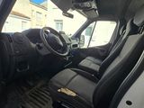 the interior of a white van with black leather seats and dashboard