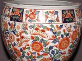 a large vase with flowers on it sitting on a table