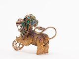 an image of a gold elephant with a green and blue head