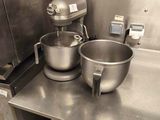 two bowls and a mixer on the counter in the kitchen