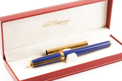un stylo bleu dans une boîte rouge posée sur une surface blanche