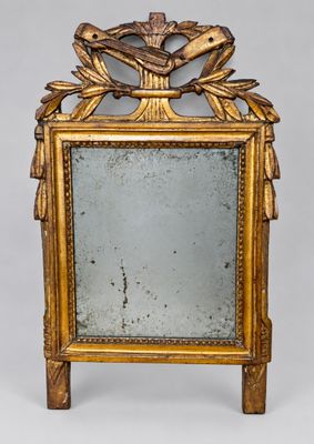 an image of a gold framed mirror with a bird on it