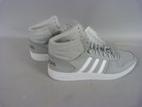 grey and white adidas sneakers with white soles on a white surface