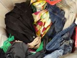 a pile of clothes that is sitting on a couch