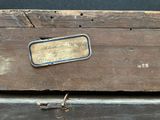 an old wooden box with a label on it