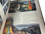 an open book with a picture of a lighthouse on it