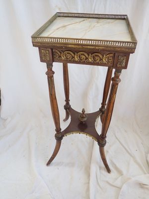 an image of a small table with a marble top on a white background