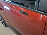 a red car with a sticker on the side of it