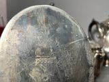 a silver plate with a tag on it on a table