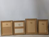 four cardboard boxes are lined up in a row on a white surface