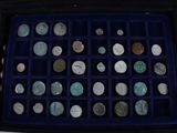 a black case with a lot of coins inside of it