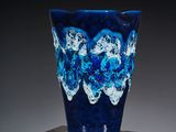 a blue vase sitting on top of a wooden box
