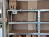 a room with shelves and boxes on the floor