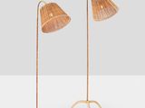 a pair of floor lamps with rattan lampshads on each of them