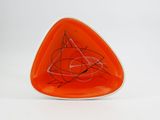 an orange triangle shaped plate with a drawing of a cat on it