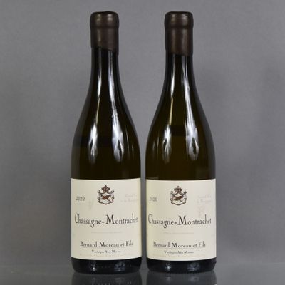 two bottles of wine sitting on top of a table next to each other