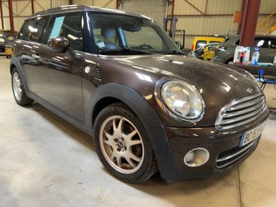 a picture of a brown mini cooper in a garage