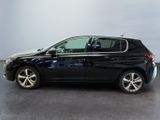 the black car is parked in a large room with a gray floor