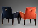 a set of three velvet chairs with a gold ring on the back