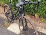 a bike leaning against a pole on the side of the road