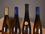 three bottles of wine are lined up on a wooden crate