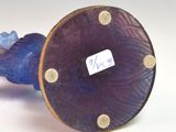 a blue vase with a purple base and a blue vase with a purple base
