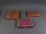 three small wooden boxes sitting on top of a table next to each other
