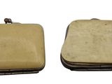 pair of small leather purses with metal clasps on white background